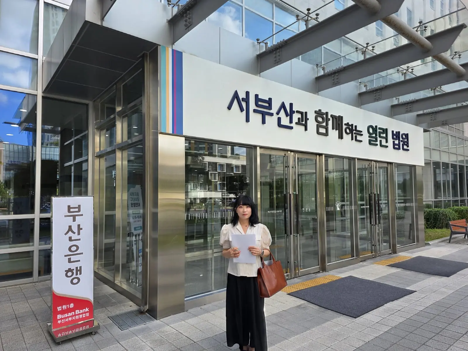 부산지방법원 서부지원 입구에서 서류를 든 안윤정 법무사